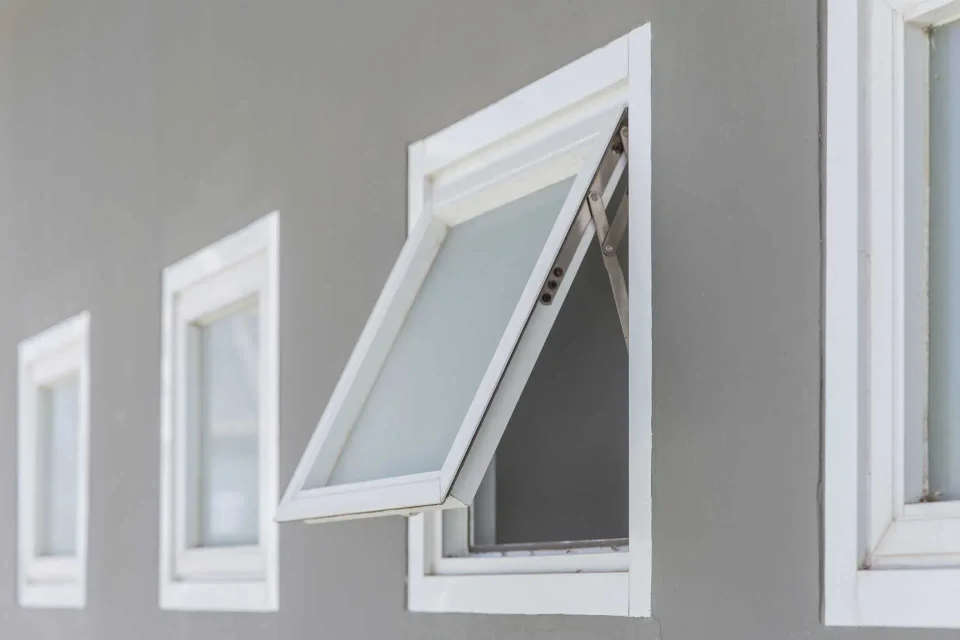 Ventana proyectante blanca abierta hacia el exterior